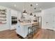 Bright, spacious kitchen with stainless appliances, white cabinets, pendant lighting and a center island at 2335 Green Symphony Pl, Oviedo, FL 32765