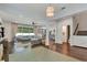 Open-concept living space features wood floors, large windows, comfortable seating, and modern decor at 2335 Green Symphony Pl, Oviedo, FL 32765