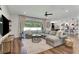 Cozy living room features a sectional couch, large windows, wood floors and modern decor at 2335 Green Symphony Pl, Oviedo, FL 32765