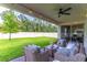 Relaxing covered patio with string lights and comfortable seating area, perfect for outdoor gatherings at 2335 Green Symphony Pl, Oviedo, FL 32765