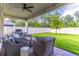 Cozy covered patio with brick flooring, ceiling fan, and outdoor seating overlooking a manicured lawn at 2335 Green Symphony Pl, Oviedo, FL 32765