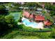 Aerial view of community pool, tennis courts, and manicured lawns and landscape at 234 Afton Sq # 305, Altamonte Springs, FL 32714