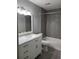 Bathroom features gray tile, white vanity with marble countertop, and a shower-tub combo at 234 Afton Sq # 305, Altamonte Springs, FL 32714