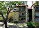 Condominium exterior showcasing balconies, a red roof, and verdant landscaping for inviting curb appeal at 234 Afton Sq # 305, Altamonte Springs, FL 32714