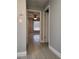 Hallway view with tiled floor leading to a bedroom with a ceiling fan and window at 234 Afton Sq # 305, Altamonte Springs, FL 32714