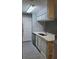 Bright kitchen featuring white cabinets, a breakfast bar, stainless steel appliances, and tiled floors at 234 Afton Sq # 305, Altamonte Springs, FL 32714