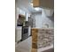 Updated kitchen showcasing a breakfast bar with stone accents, white cabinets, and stainless appliances at 234 Afton Sq # 305, Altamonte Springs, FL 32714