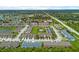 Aerial view of the community, showcasing a pool, playground, lush landscaping, and modern townhomes at 2502 Seven Oaks Dr, St Cloud, FL 34772
