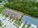 Aerial view of townhome community, showcasing green spaces, walking paths, and residential buildings at 2502 Seven Oaks Dr, St Cloud, FL 34772