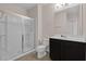 Clean bathroom features a glass enclosed shower, toilet, and a dark wood vanity at 2502 Seven Oaks Dr, St Cloud, FL 34772