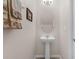 Pedestal sink in the bathroom with decorative towels and modern fixtures at 2502 Seven Oaks Dr, St Cloud, FL 34772