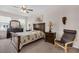 Comfortable bedroom featuring a dark wood bed frame, ceiling fan, and neutral wall color at 2502 Seven Oaks Dr, St Cloud, FL 34772