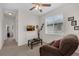 Upstairs bonus room provides extra living space with a ceiling fan and natural light from the window at 2502 Seven Oaks Dr, St Cloud, FL 34772