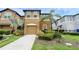 Charming townhome featuring a two-car garage, manicured landscaping, and a welcoming front entrance at 2502 Seven Oaks Dr, St Cloud, FL 34772