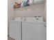 Bright laundry room features both a washing machine and a dryer at 2502 Seven Oaks Dr, St Cloud, FL 34772