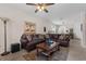 Spacious living room featuring a leather sofa, stylish decor, and a cozy atmosphere at 2502 Seven Oaks Dr, St Cloud, FL 34772
