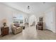 Inviting living room area with tile floors, neutral walls, and large windows for ample natural light at 2502 Seven Oaks Dr, St Cloud, FL 34772