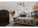 Main bedroom features a ceiling fan, a window for natural light, a dresser, and neutral paint at 2502 Seven Oaks Dr, St Cloud, FL 34772
