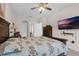 Main bedroom features a large bed, a ceiling fan, and an attached bathroom, providing a private retreat at 2502 Seven Oaks Dr, St Cloud, FL 34772