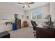Office space featuring a ceiling fan, desk, and window that provides ample natural light at 2502 Seven Oaks Dr, St Cloud, FL 34772