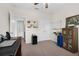 Office space featuring a ceiling fan, desk, whiteboard and cabinets at 2502 Seven Oaks Dr, St Cloud, FL 34772
