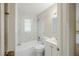 Bathroom with white tile, tub and shower combination, and modern vanity at 26 Channing Ave, Orlando, FL 32811