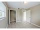 The bedroom has a closet, neutral walls, and a tiled floor with access to other rooms at 26 Channing Ave, Orlando, FL 32811