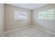 Bright bedroom featuring neutral walls, tile floors, and windows with natural light at 26 Channing Ave, Orlando, FL 32811
