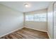 Bright bedroom featuring wood-look flooring, neutral walls, and a window with natural light at 26 Channing Ave, Orlando, FL 32811