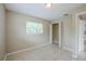 Cozy bedroom with a closet, neutral walls, tiled floor, and natural light from the window at 26 Channing Ave, Orlando, FL 32811