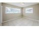 Bedroom featuring tile flooring, neutral walls, and a window with natural light at 26 Channing Ave, Orlando, FL 32811