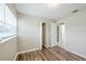 Bedroom with neutral walls, wood-look flooring, closet and doorway to another room at 26 Channing Ave, Orlando, FL 32811