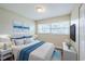 Inviting bedroom with a comfortable bed, matching nightstands, and natural light from a window at 26 Channing Ave, Orlando, FL 32811
