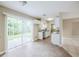 Bright dining area with wood floors, sliding glass doors, and an open view of the kitchen at 26 Channing Ave, Orlando, FL 32811