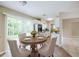 Cozy dining area featuring a round wood table, upholstered chairs, and sliding glass doors for natural light at 26 Channing Ave, Orlando, FL 32811