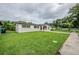 Single Gathering home with vibrant green lawn leading to the front entrance and long driveway at 26 Channing Ave, Orlando, FL 32811