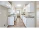 Efficient kitchen with white cabinets, granite countertops, and modern fixtures at 26 Channing Ave, Orlando, FL 32811