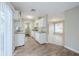 Well-lit kitchen featuring white cabinets, granite countertops, and a view into the dining area at 26 Channing Ave, Orlando, FL 32811
