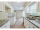 Spacious kitchen with granite countertops, white cabinetry, and an open floor plan at 26 Channing Ave, Orlando, FL 32811