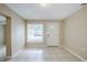 Bright living room showcasing neutral walls, tile floors, and a front door with decorative glass at 26 Channing Ave, Orlando, FL 32811