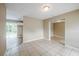Open living area with tile flooring, neutral walls, sliding glass doors to the backyard, and an open layout at 26 Channing Ave, Orlando, FL 32811