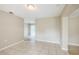 Spacious living room boasts tile flooring, neutral walls, and an open layout with backyard access at 26 Channing Ave, Orlando, FL 32811