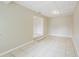 Open living room features tile flooring, neutral walls, and a split-level entrance to a dining area at 26 Channing Ave, Orlando, FL 32811