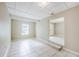 Bright living room with tiled floors, neutral walls, an open layout with a partial view of the kitchen at 26 Channing Ave, Orlando, FL 32811