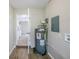 Functional utility area with a water heater, electrical panel, and access to other areas at 26 Channing Ave, Orlando, FL 32811