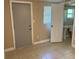 Bedroom featuring tile flooring, access to a bathroom and backyard at 2847 W Harwood St # 0, Orlando, FL 32805