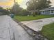 Street view of home for sale with gray exterior, green lawn, and mature trees at 2847 W Harwood St # 0, Orlando, FL 32805