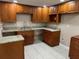 Kitchen area featuring wood cabinetry, laminate flooring, and granite countertops at 2847 W Harwood St # 0, Orlando, FL 32805