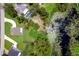 Aerial view showing a home with a private pool and dock access to a lily pad covered lake at 300 Mitnik Dr, Deltona, FL 32738