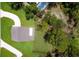 Aerial view showing a home with a private pool and verdant surroundings next to the water at 300 Mitnik Dr, Deltona, FL 32738